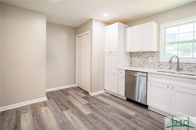 kitchen featuring white cabinetry, dishwasher, sink, and backsplash