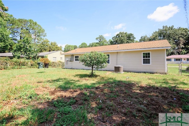 back of house featuring a yard and central AC unit