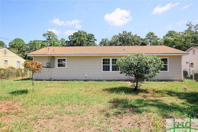 back of house with a yard