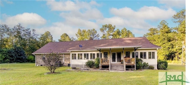 rear view of property with a wooden deck and a lawn