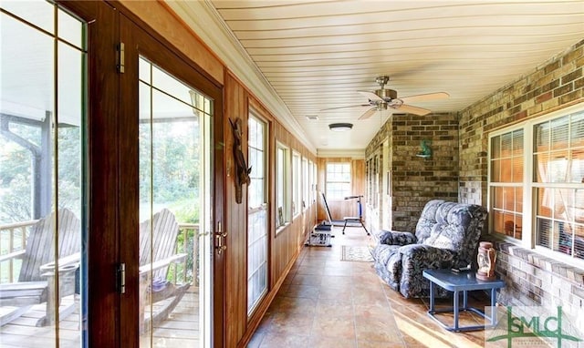 sunroom / solarium featuring ceiling fan