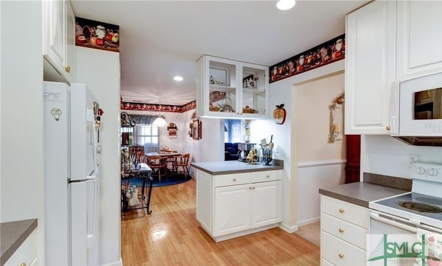 kitchen featuring white cabinetry, white appliances, and light wood-type flooring