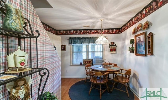 dining space with hardwood / wood-style flooring