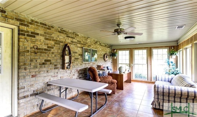 sunroom / solarium featuring ceiling fan