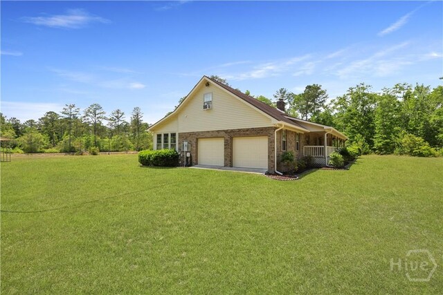 1280 Little Mccall Rd, Guyton, GA 31312 - view of side of property with a lawn, brick siding, and an attached garage