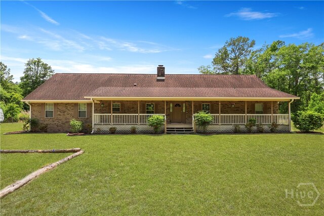 1280 Little Mccall Rd, Guyton, GA 31312 - rear view of house with covered porch, a lawn, a chimney, and brick siding