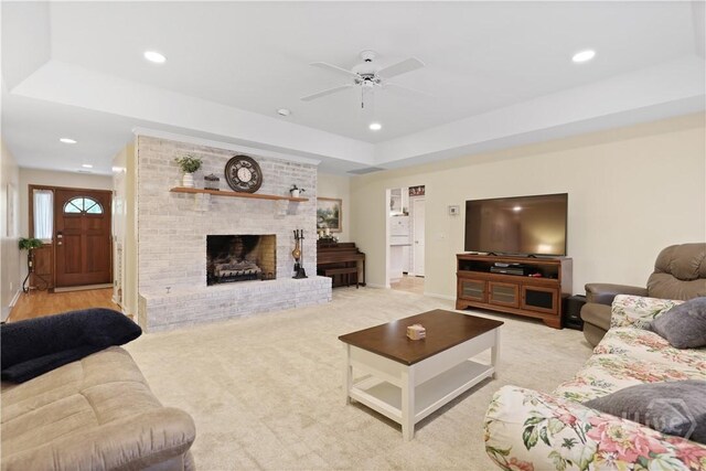 1280 Little Mccall Rd, Guyton, GA 31312 - living room with ceiling fan, a raised ceiling, recessed lighting, baseboards, and a brick fireplace