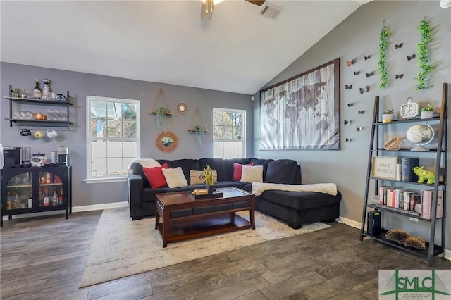 living room with vaulted ceiling and dark hardwood / wood-style floors