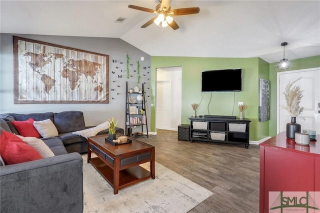 living room with ceiling fan, vaulted ceiling, and hardwood / wood-style floors