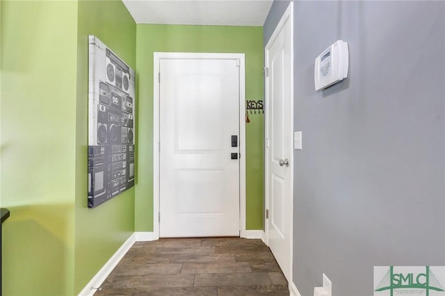 doorway with dark hardwood / wood-style flooring and mail boxes