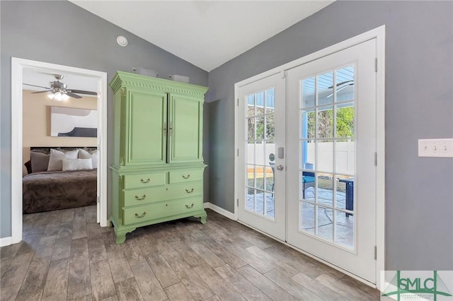 doorway to outside with hardwood / wood-style floors, vaulted ceiling, and french doors