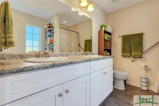 bathroom with hardwood / wood-style flooring, vanity, toilet, and a shower with shower curtain