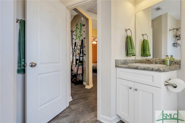 bathroom with hardwood / wood-style flooring and vanity