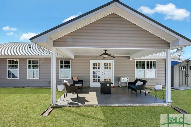 back of house with a storage shed, a patio area, ceiling fan, and a lawn