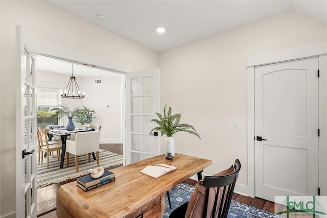 dining room featuring dark hardwood / wood-style flooring and a chandelier