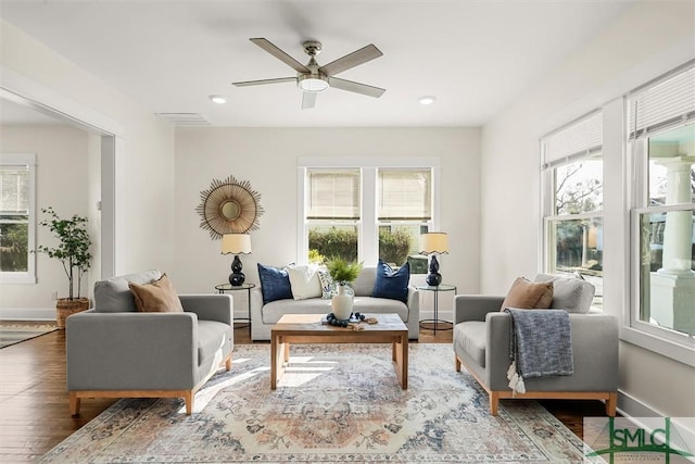 living room with hardwood / wood-style flooring and ceiling fan