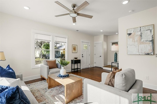 living room featuring ceiling fan and dark hardwood / wood-style flooring