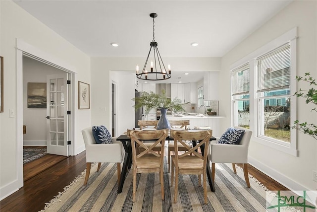 dining room featuring baseboards, a chandelier, dark wood-type flooring, and recessed lighting