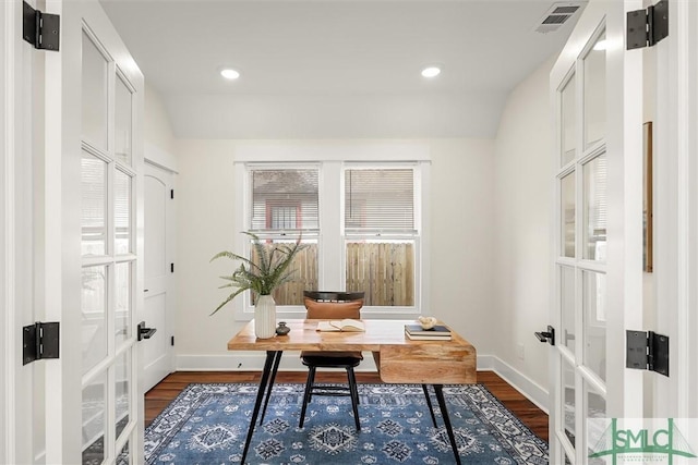 office with dark wood-type flooring and french doors