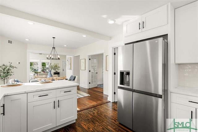 kitchen with pendant lighting, white cabinetry, dark hardwood / wood-style floors, stainless steel refrigerator with ice dispenser, and light stone countertops