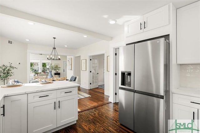 kitchen with white cabinets, dark wood finished floors, pendant lighting, a chandelier, and stainless steel refrigerator with ice dispenser