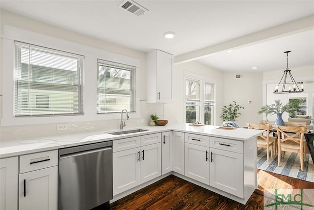 kitchen featuring stainless steel dishwasher, a sink, visible vents, a peninsula, and dark wood-style floors