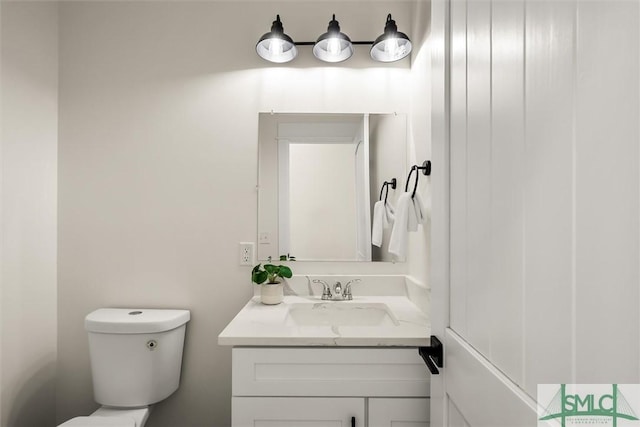 bathroom with toilet and vanity