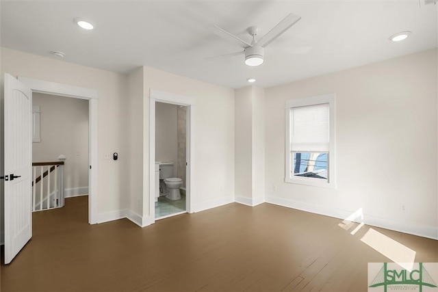 unfurnished bedroom featuring ensuite bath, baseboards, recessed lighting, and dark wood-style flooring