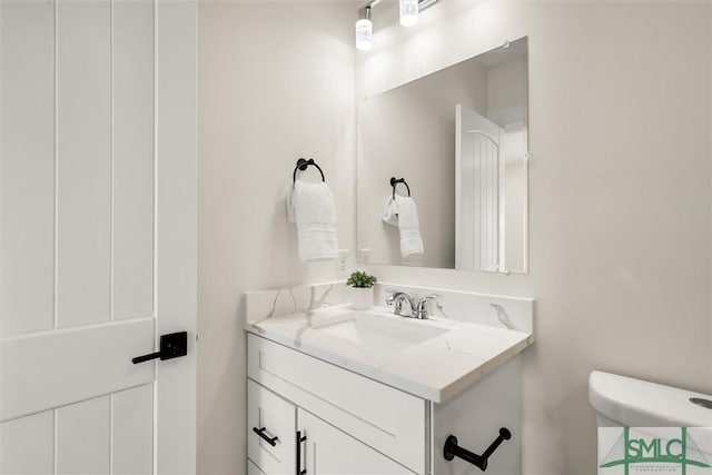bathroom with toilet and vanity