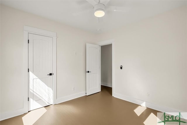 unfurnished bedroom with a ceiling fan and baseboards