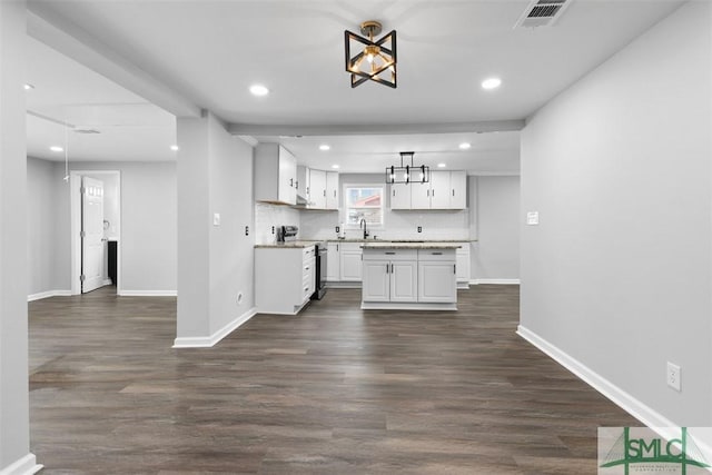 kitchen featuring pendant lighting, sink, stainless steel electric range, dark wood-type flooring, and white cabinets