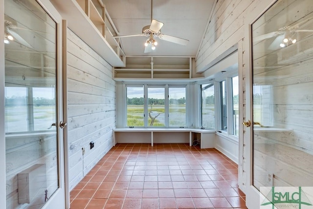 unfurnished sunroom with vaulted ceiling and ceiling fan