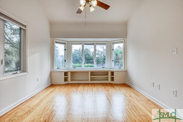 spare room featuring plenty of natural light, ceiling fan, and light hardwood / wood-style flooring