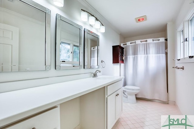 bathroom with vanity, ornamental molding, tile patterned floors, and toilet