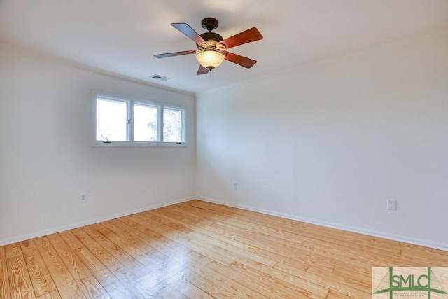 empty room with ceiling fan, ornamental molding, and light wood-type flooring