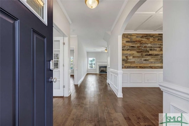 foyer entrance featuring crown molding, ceiling fan, and dark hardwood / wood-style flooring