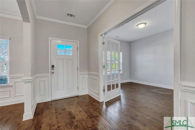 entrance foyer featuring ornamental molding and dark wood-type flooring