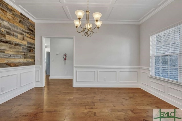 unfurnished dining area with crown molding, coffered ceiling, hardwood / wood-style floors, and a notable chandelier