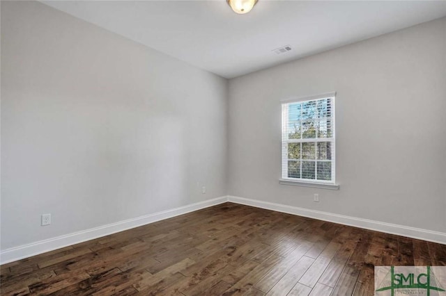 empty room with dark hardwood / wood-style floors