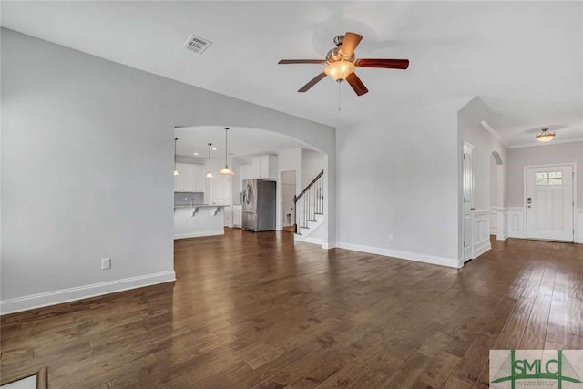 unfurnished living room with ceiling fan and dark hardwood / wood-style flooring