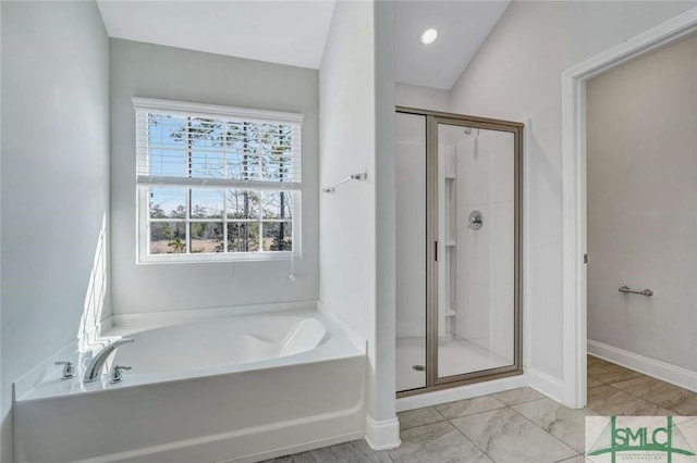 bathroom with tile patterned floors and independent shower and bath