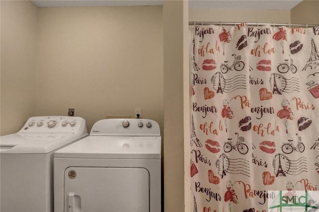 washroom with washing machine and clothes dryer