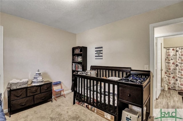 carpeted bedroom with a textured ceiling