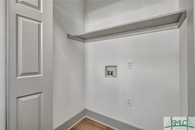 washroom with laundry area, baseboards, washer hookup, and wood finished floors