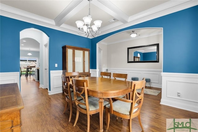 dining space with an inviting chandelier, beam ceiling, and dark hardwood / wood-style flooring