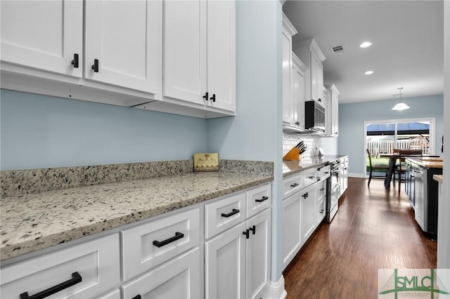 kitchen featuring white cabinetry, light stone counters, and decorative light fixtures