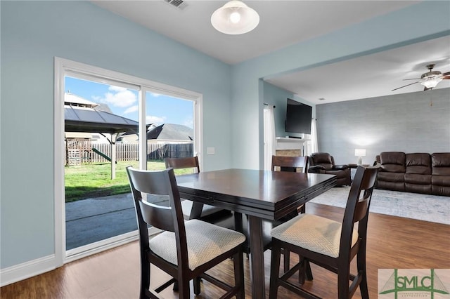 dining space featuring hardwood / wood-style floors and ceiling fan