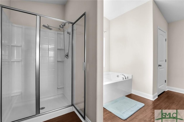 bathroom featuring independent shower and bath and hardwood / wood-style floors