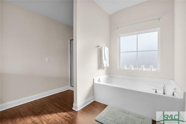 bathroom featuring hardwood / wood-style flooring and shower with separate bathtub