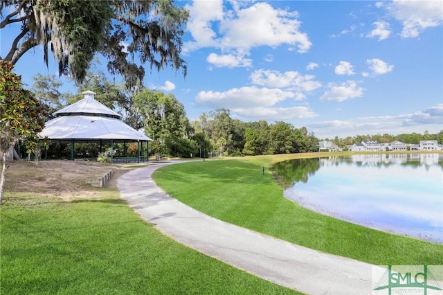 view of property's community featuring a gazebo, a lawn, and a water view